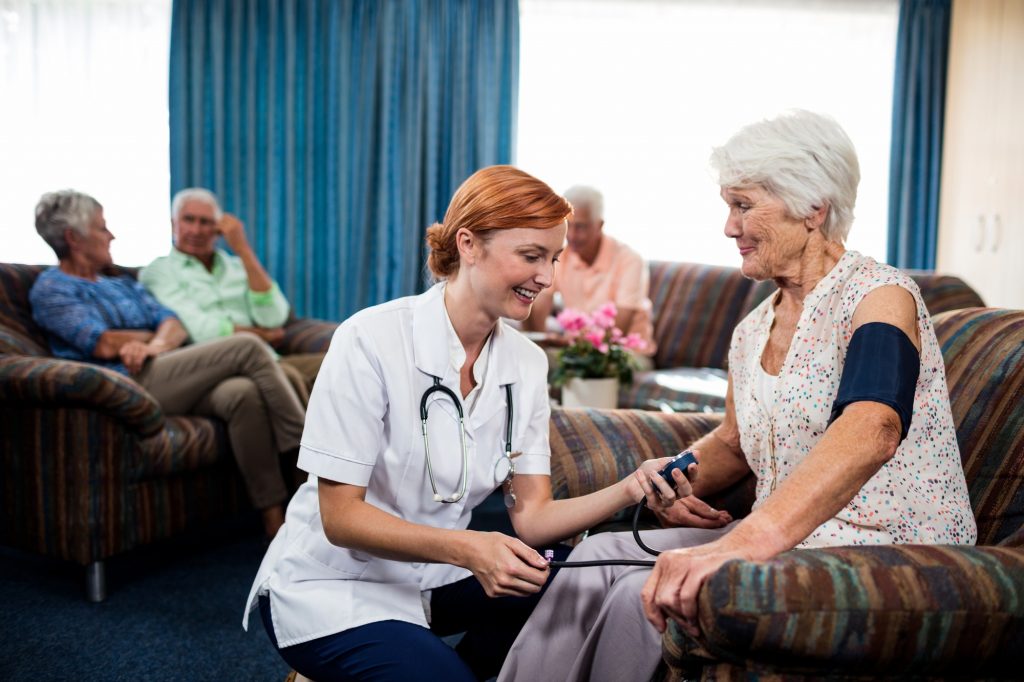 Nurse taking care of pensioner