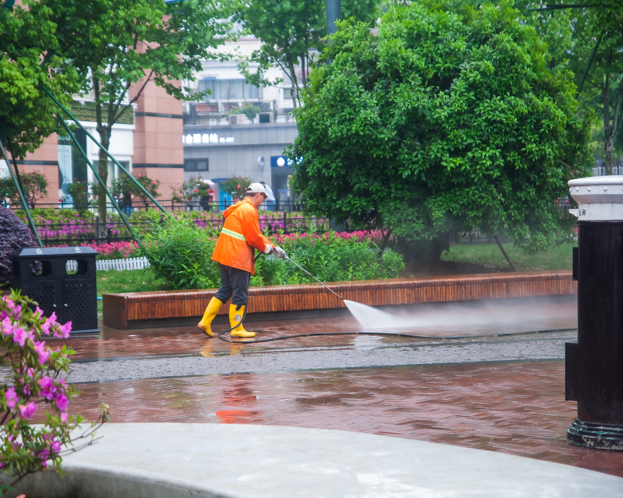 worker washing the pavement road in Wuhan, China